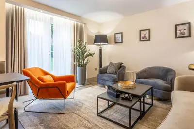 a living room with a couch and chairs and a table at Arran Shores Luxury Shorefront Garden Terrace Apartment 7 in Lamlash