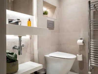 a small bathroom with a toilet and a shower at Arran Shores Luxury Shorefront Garden Terrace Apartment 7 in Lamlash