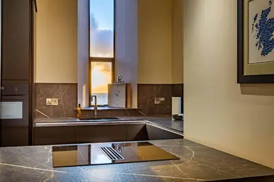 a kitchen with a counter top and a window at Arran Shores Luxury Shorefront Suite 1 in Lamlash