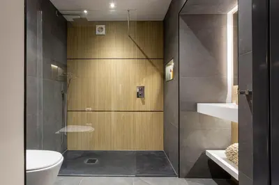 a bathroom with a shower and a toilet and a sink at Arran Shores Luxury Shorefront Suite 1 in Lamlash
