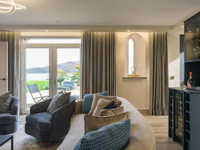 a living room with a couch and chairs and a window at Arran Shores Luxury Shorefront Suite 1 in Lamlash