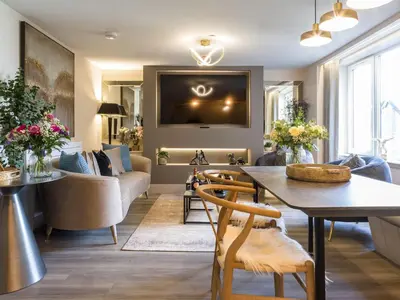 a living room with a table and a couch at Arran Shores Luxury Shorefront Apartment 9 in Lamlash