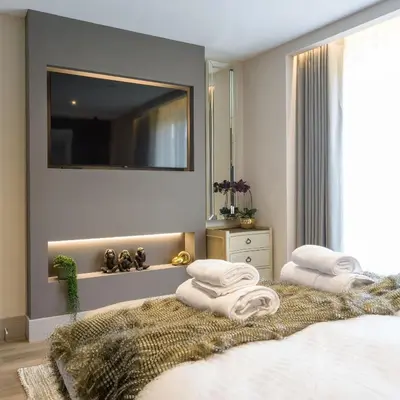 a bedroom with a bed with towels on it at Arran Shores Luxury Shorefront Penthouse Suite 11 in Lamlash