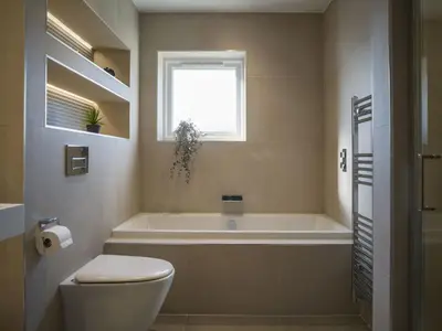 a bathroom with a tub and a toilet and a window at Arran Shores Luxury Shorefront Penthouse Suite 10 in Lamlash