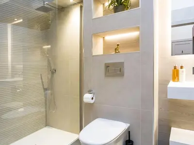 a bathroom with a shower and a toilet and a sink at Arran Shores Luxury Shorefront Penthouse Suite 13 in Lamlash