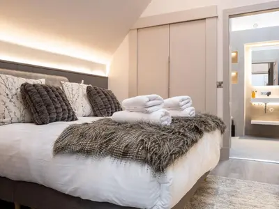 a bedroom with a bed with white towels on it at Arran Shores Luxury Shorefront Penthouse Suite 13 in Lamlash
