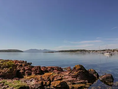 a view of a body of water with rocks at 8 George Street in Millport