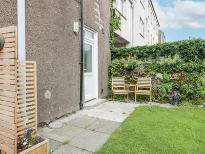 a patio with two chairs in front of a building at 8 George Street in Millport