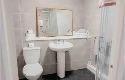 a bathroom with a toilet and a sink and a mirror at Glasgow City - 1 Bedroom Apartment in Glasgow