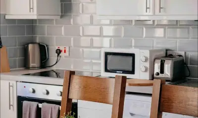 a kitchen with a microwave oven and a stove at Glasgow City - 1 Bedroom Apartment in Glasgow