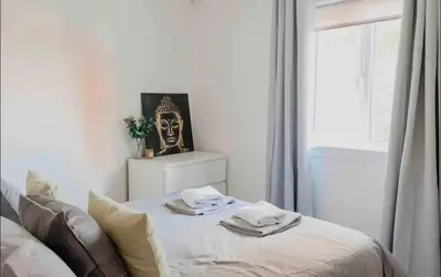 a bedroom with a bed with towels on it at Glasgow City - 1 Bedroom Apartment in Glasgow
