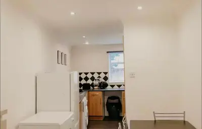 a kitchen with a white refrigerator and a counter at Glasgow - 1 Bedroom Apartment in Glasgow