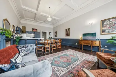 a living room with a couch and a table at Grand 2 Bed West End Residence in Glasgow