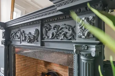 an ornate fireplace with a black mantel at Grand 2 Bed West End Residence in Glasgow