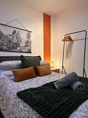 a bedroom with a bed with a black blanket on it at Stylish 2 bed City Retreat in Glasgow