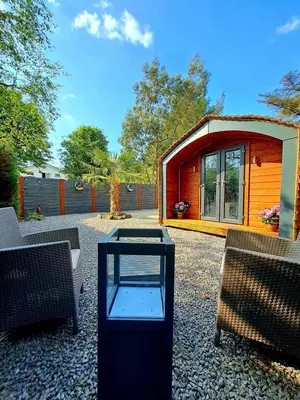 a small house with a glass table in front of it at Pod at Lonan drive in Oban