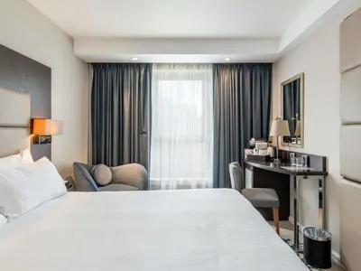 a hotel room with a bed and a desk at Mercure Edinburgh Haymarket in Edinburgh