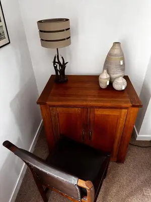 a wooden desk with a lamp and a chair at Thornhill cottage with views of the Trossachs in Thornhill