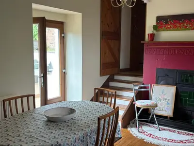 a dining room with a table and a fireplace at 11 George Street Doune in Stirling