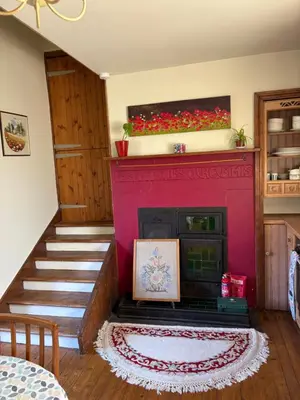 a living room with a red fireplace and stairs at 11 George Street Doune in Stirling