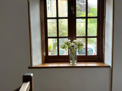 a vase of flowers sitting on a window sill at 11 George Street Doune in Stirling