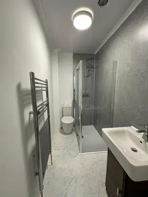 a bathroom with a shower and a sink and a toilet at Spacious 5 Bedroom House Close to Central West End in Glasgow