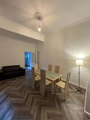 a dining room with a table and chairs and a couch at Spacious 5 Bedroom House Close to Central West End in Glasgow