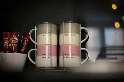 two coffee mugs sitting on top of a table at Charming 2 Bed Apartment in the heart of the West End in Glasgow