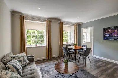 a living room with a couch and a table at New Lanark Self Catering Waterhouses in Lanark