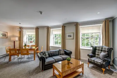 a living room with two couches and a table at New Lanark Self Catering Waterhouses in Lanark