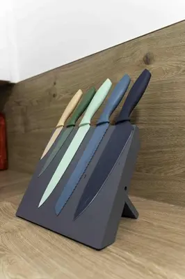 a knife block with four knives in it on a table at 2 BDR House By Caledonia Luxe Stays Short Lets & Serviced Accommodation Glasgow in Glasgow