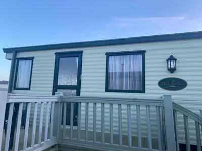 a house with a balcony with a sign on it at The Wee Sprout in Stranraer