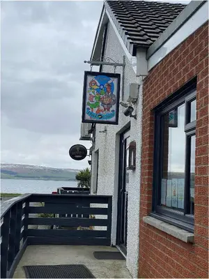 a sign on the side of a building with a window at The Wee Sprout in Stranraer