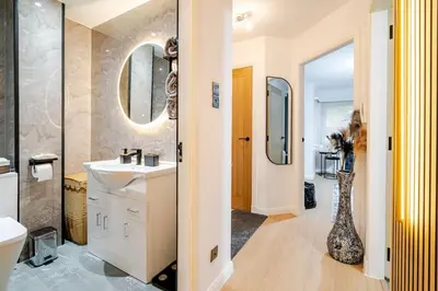 a bathroom with a sink and a mirror at The Pad in Paisley