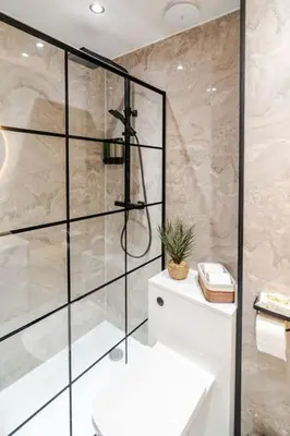 a bathroom with a shower and a white sink at The Pad in Paisley