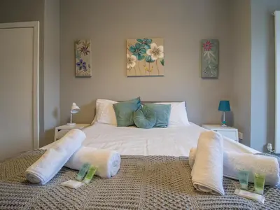 a bedroom with a large white bed with two pillows at Wonderful West End - Pass the Keys in Glasgow