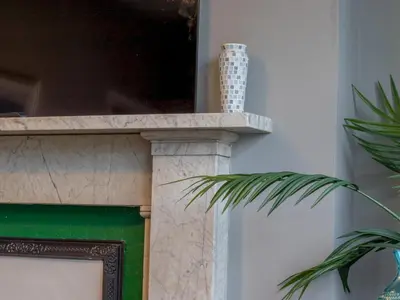 a green and white fireplace with a green door at Wonderful West End - Pass the Keys in Glasgow