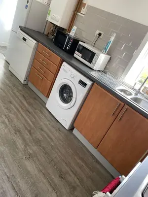 a kitchen with a washing machine and a sink at 3 bedroom terraced house in Larkhall