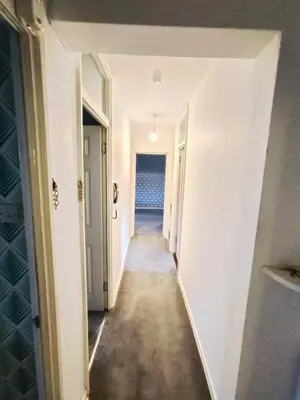 a hallway leading to a room with white walls at Modern 2-in-1 Retreat for Groups in Port Glasgow