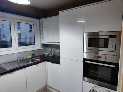 a kitchen with a sink and a microwave at Modern 2-in-1 Retreat for Groups in Port Glasgow