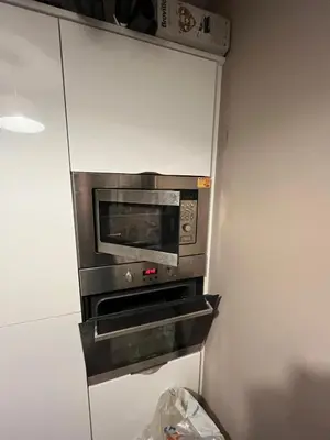 a microwave oven sitting inside of a kitchen at Modern 2-in-1 Retreat for Groups in Port Glasgow