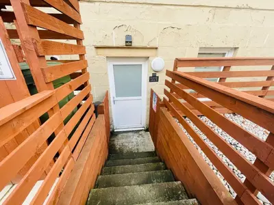 a stairway with wooden railings and a white door at City Gem Main Door Parking - Pass the Keys in Glasgow