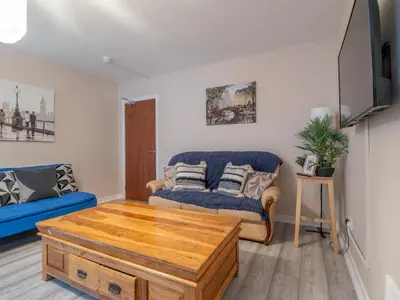 a living room with a couch and a coffee table at City Gem Main Door Parking - Pass the Keys in Glasgow