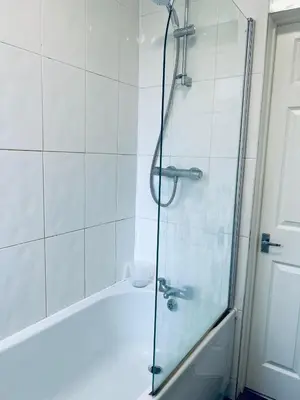 a bathroom with a shower with a glass door at Blue Heaven Apartments in Edinburgh