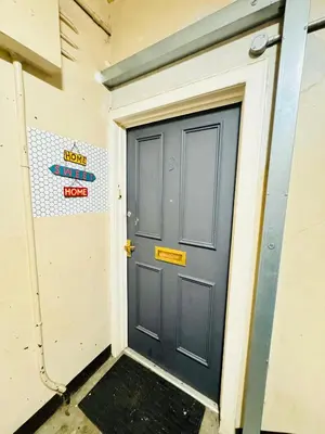a door in a building with a sign on it at Blue Heaven Apartments in Edinburgh