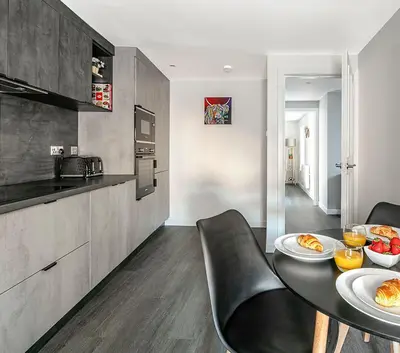 a kitchen with a table with plates of food on it at Castle Street Apartments - Luxury Ettrick Apartment in Rothesay