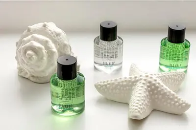 a group of three bottles of soap and a starfish at Castle Street Apartments - Luxury Ettrick Apartment in Rothesay