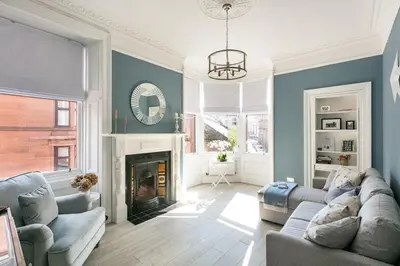 a living room with a couch and a fireplace at Boutique West End Apartment - 'The Nook' in Glasgow