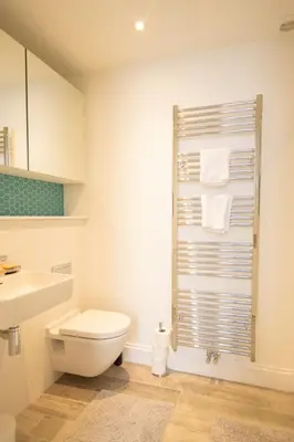 a white bathroom with a toilet and a sink at Stunning 3 Bed Flat in the Heart of the West End in Glasgow