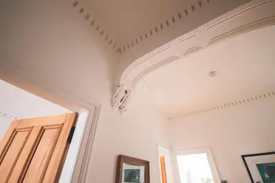 a room with a coffered ceiling and a window at Stunning 3 Bed Flat in the Heart of the West End in Glasgow